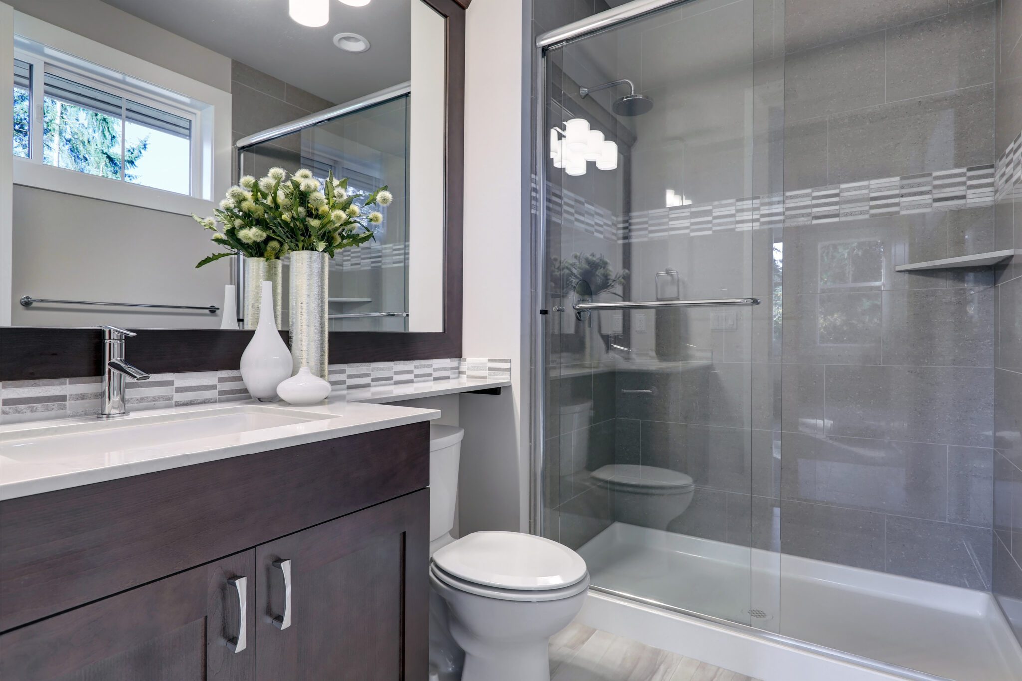 Shower glass in new bathroom with silver frame and bar