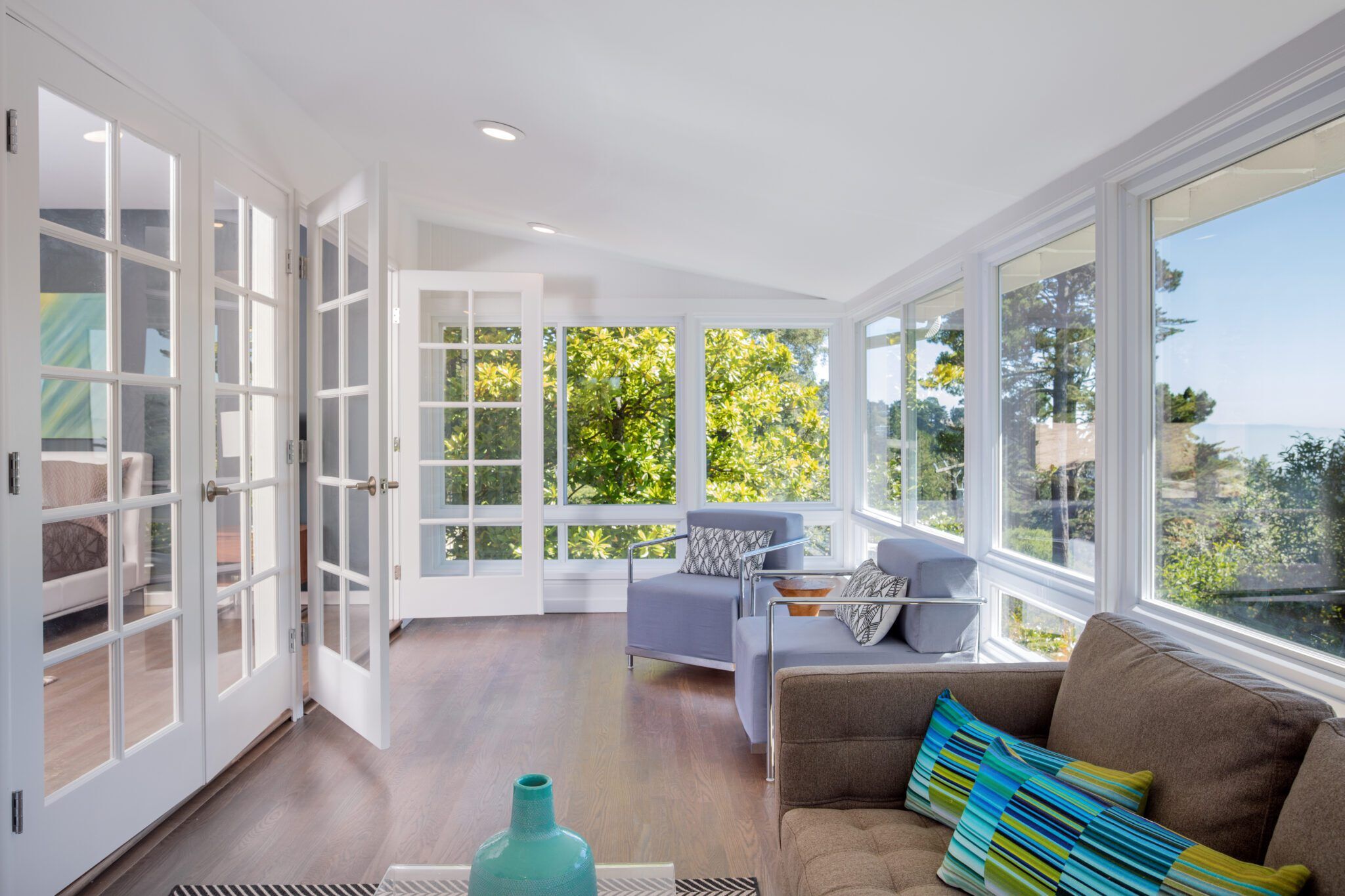 Sunroom with doors and wood floors