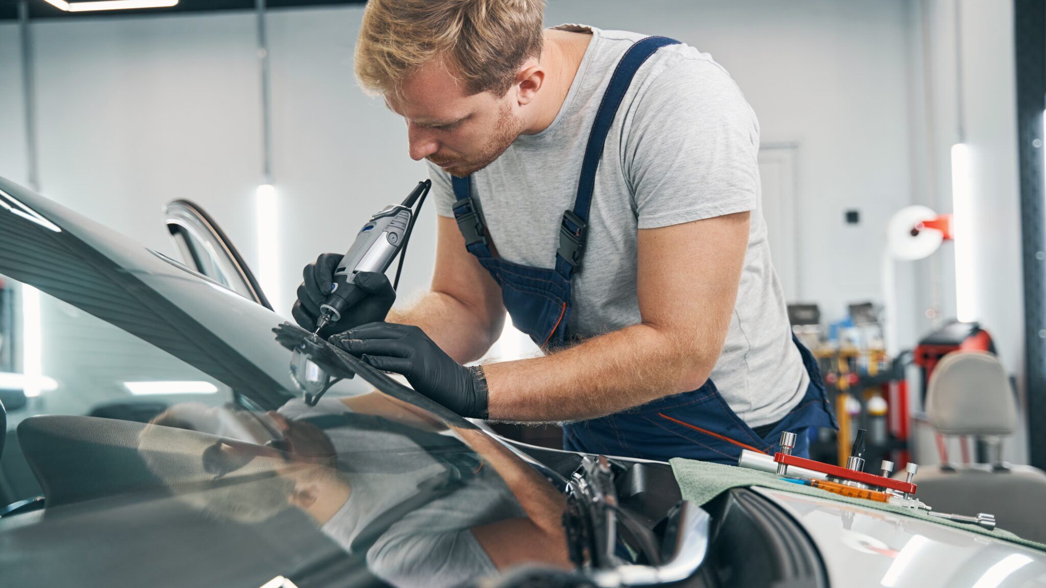 GoGlass employee repairing broken car windshield in Dover, DE