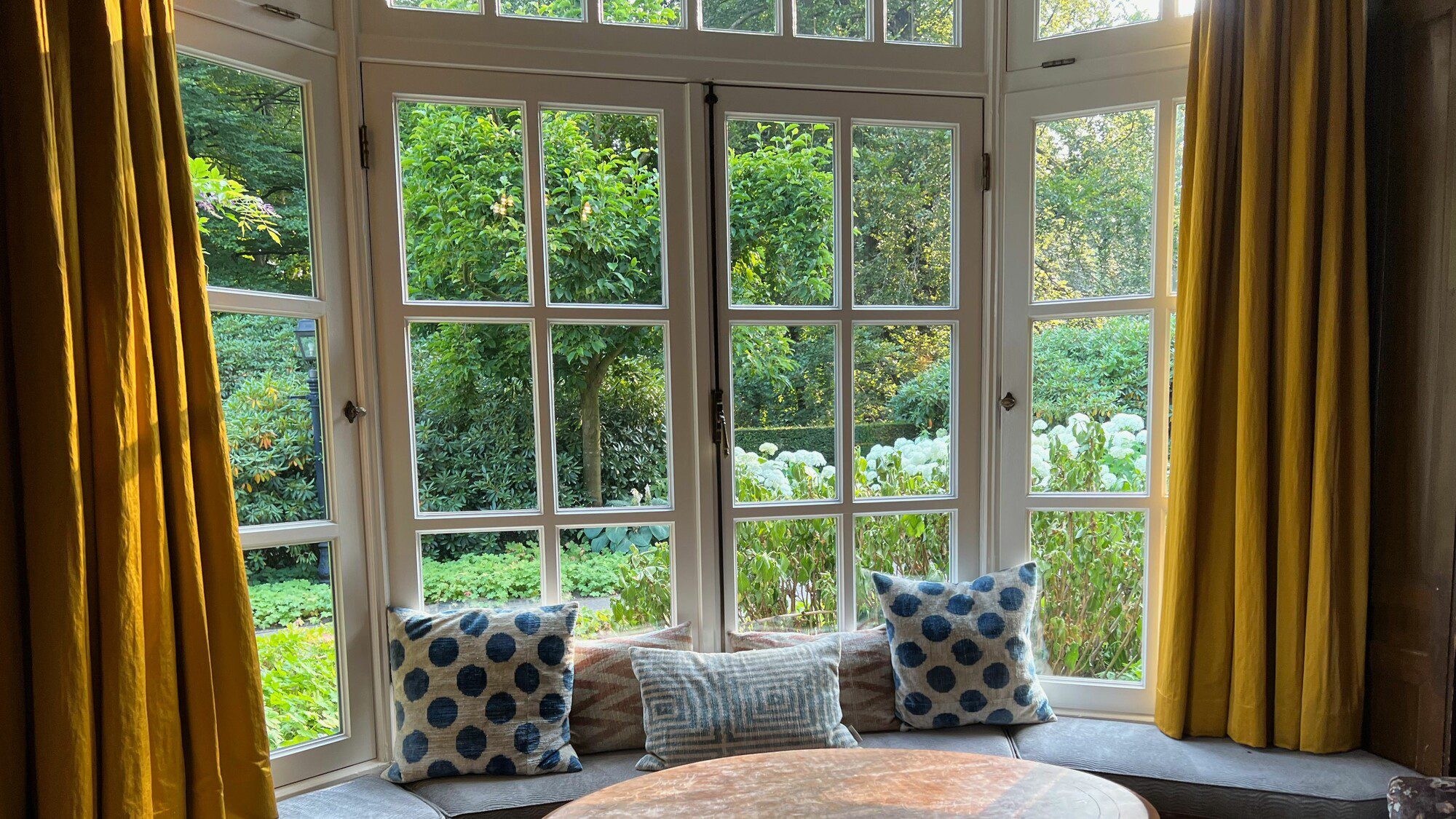 Interior of beautiful new windows looking out to a green garden view