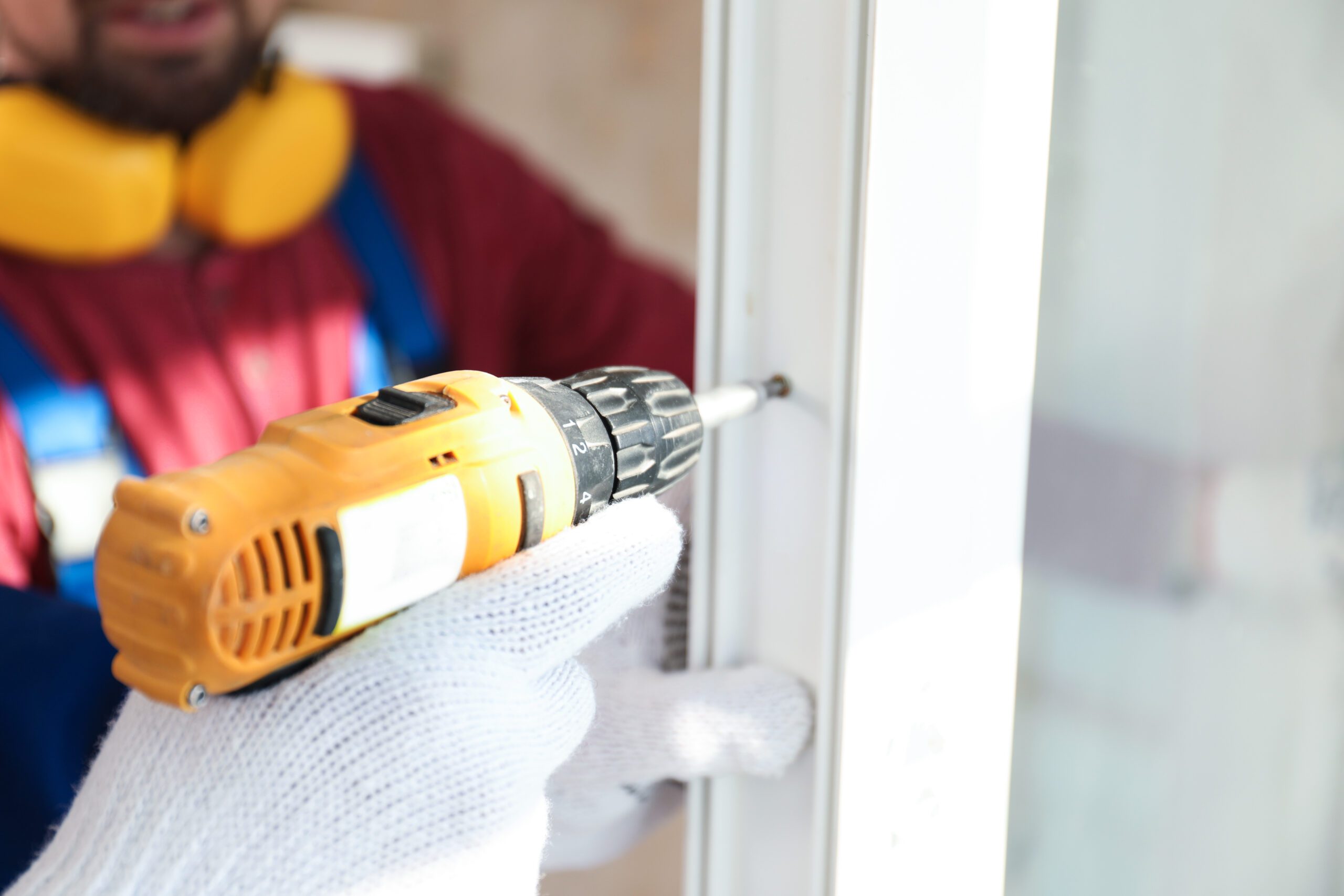 Closeup of gloved hands of technician installing replacement window